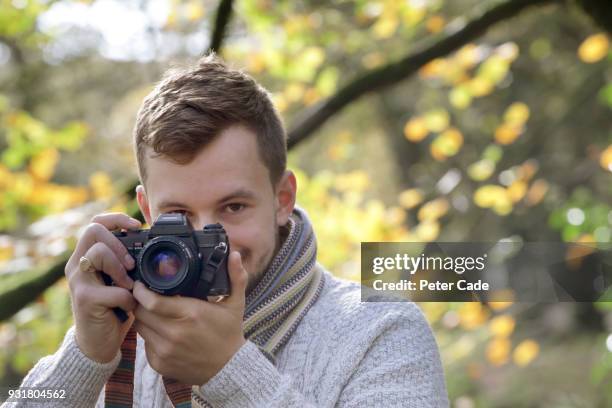 man taking photo in woodland - spiegelreflexcamera stockfoto's en -beelden