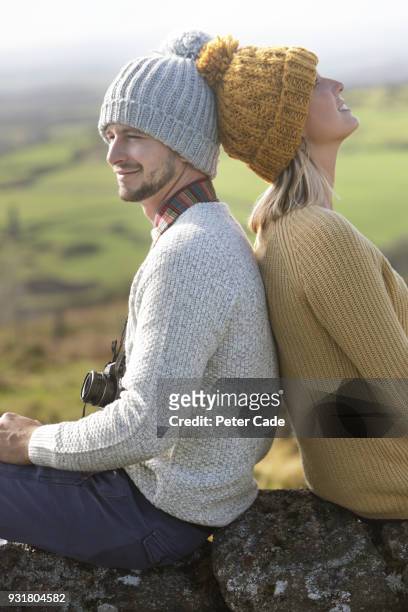 hiking couple resting on stone wall - bodmin moor stock pictures, royalty-free photos & images