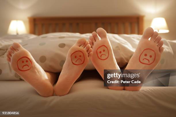 couples unhappy feet in bed - attività sessuale umana foto e immagini stock