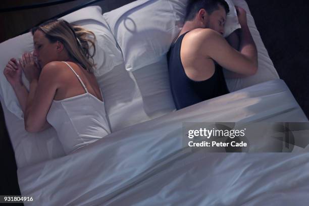 young couple back to back in bed - sad husband stock pictures, royalty-free photos & images