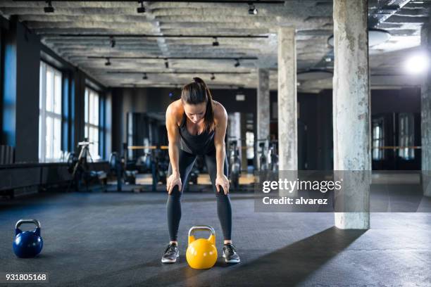 tired athlete standing with hands on knees in gym - standing with hands on knees imagens e fotografias de stock