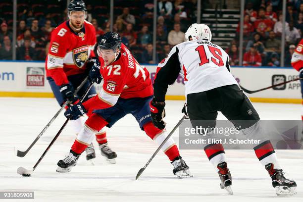 Frank Vatrano of the Florida Panthers skates with the puck against Zack Smith of the Ottawa Senators at the BB&T Center on March 12, 2018 in Sunrise,...