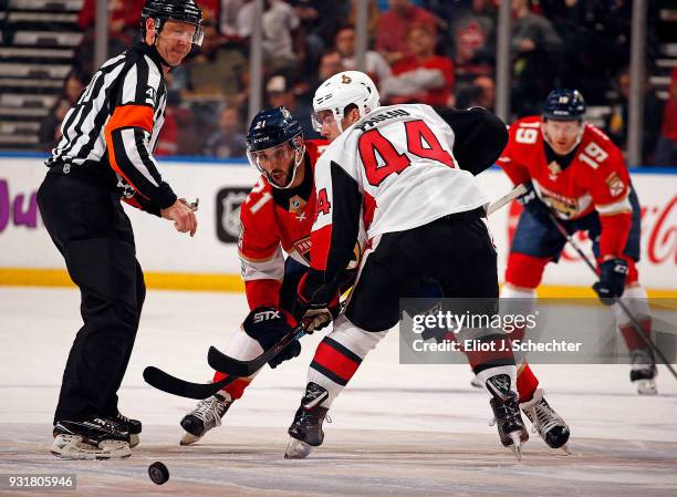 Referee Steve Kozari drops the puck for a face off between Vincent Trocheck of the Florida Panthers and Jean-Gabriel Pageau of the Ottawa Senators at...