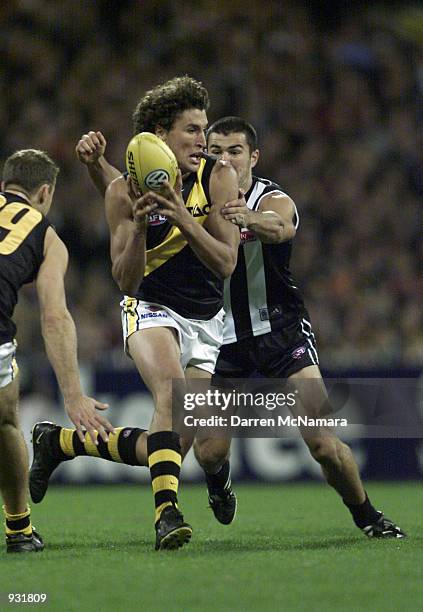 Chris Tarrant for Collingwood tackles Darren Gaspar for Richmond, in the match between the Collingwood Magpies and the Richmond Tigers, during round...