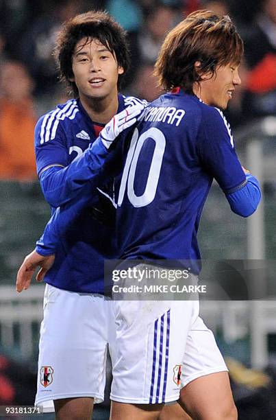 Japan's Atsuto Uchida celebrates with teammate Shunsuke Nakamura after their team scored against Hong Kong in their Group A Asian Cup qualifying...