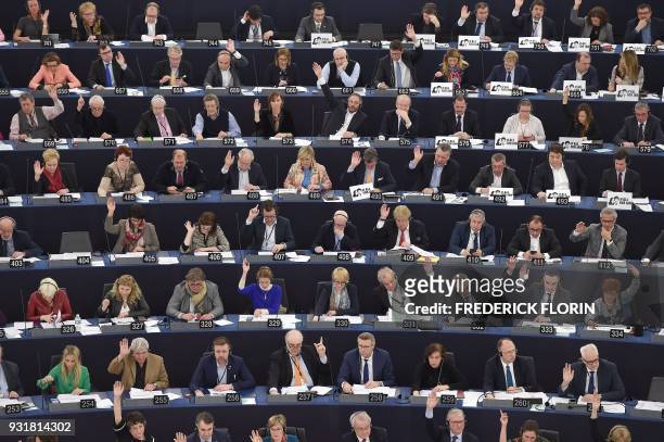 Members of the European Parliament take part in a voting session at the European Parliament on March 14, 2018 in Strasbourg, eastern France. / AFP...