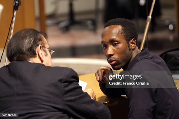 Rudy Guede , who was born in the Ivory Coast, chats with his lawyer's assistant in the Perugia courthouse during the sitting of his appeal against...