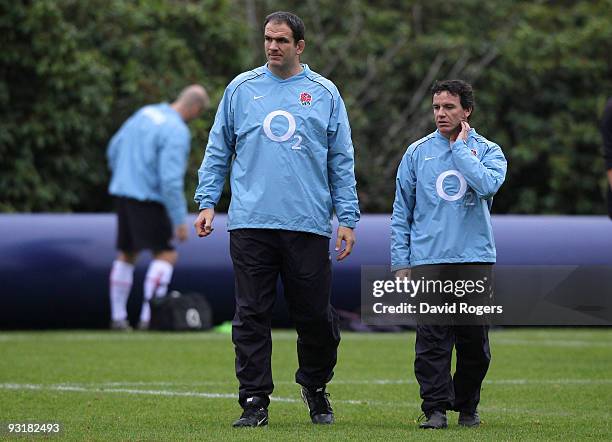 Martin Johnson the England head coach watches his squad with defence coach Mike Ford during an England training session at Pennyhill Park on November...