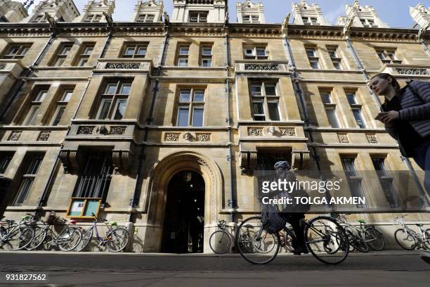 Students pass Gonville and Caius College, where British physicist Stephen Hawking was a fellow for over 50 years, at Cambridge University in...