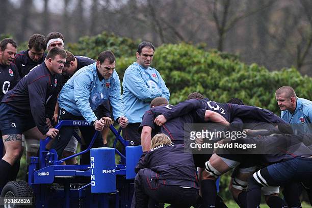 Martin Johnson the England head coach watches assistant John Wells and his squad practice during an England training session at Pennyhill Park on...