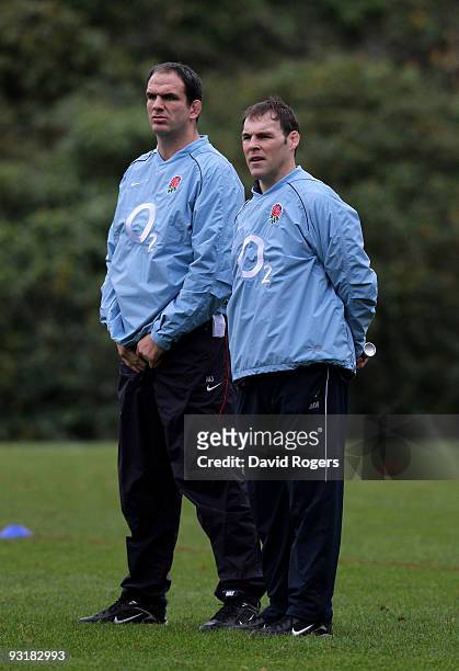 Martin Johnson the England head coach watches practice with his assistant John Wells during an England training session at Pennyhill Park on November...