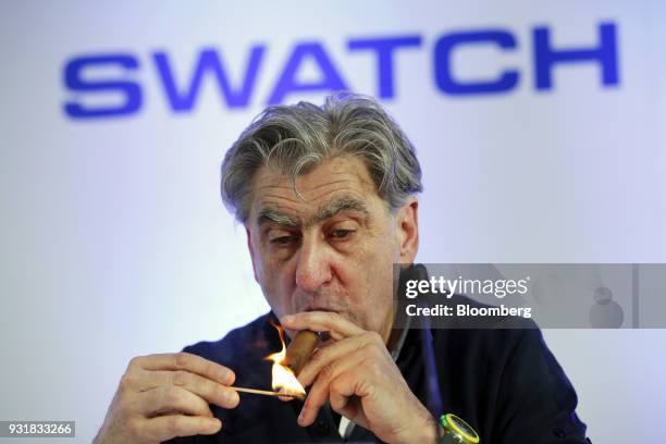 Nick Hayek, chief executive officer of Swatch Group AG, lights a cigar during a news conference to announce the company's full year results in Biel,...