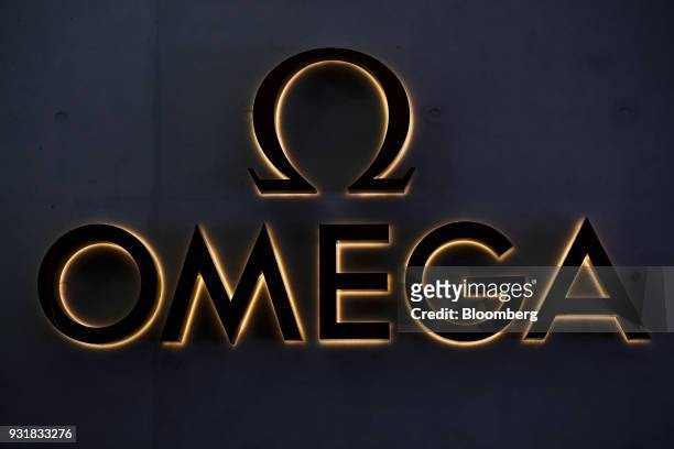 An illuminated Omega SA company logo is displayed during a news conference to announce Swatch Group AG's full year results in Biel, Switzerland, on...