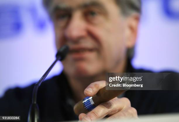 Nick Hayek, chief executive officer of Swatch Group AG, smokes a cigar during a news conference to announce the company's full year results in Biel,...