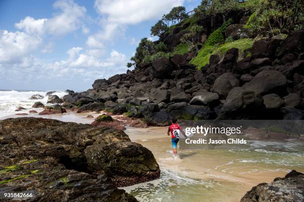 Local surfer Joel Parkinson sneaks out into the surf away from the masses of spectators at Snapper Rocks, Coolangatta for The Quiksilver Pro Gold...