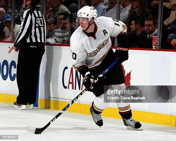 Corey Perry of the Anaheim Ducks skates along the boards with the puck during a NHL game at Joe Louis Arena on November 14, 2009 in Detroit,...