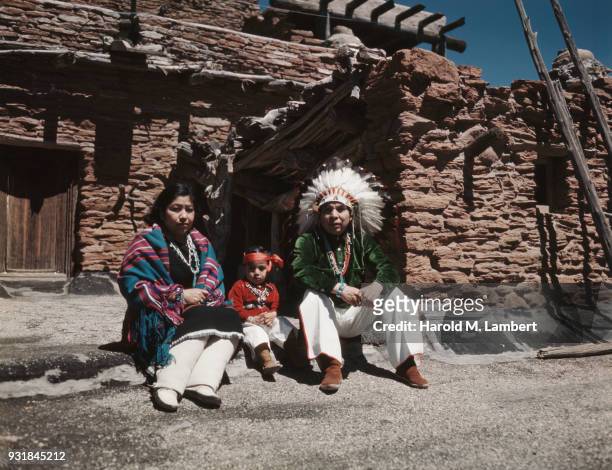 Portrait of Native American family in front of wall