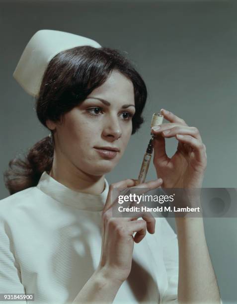 Portrait of young nurse in uniform, smiling, close-up