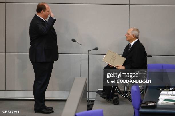 German Chief of Staff Helge Braun takes the oath as he is sworn in by the President of the Bundestag Wolfgang Schaeuble during the new government's...