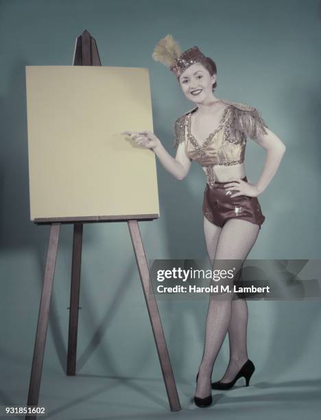 Portrait of young cheerleader standing near whiteboard