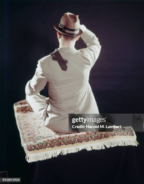 Rear view of man sitting on magic carpet