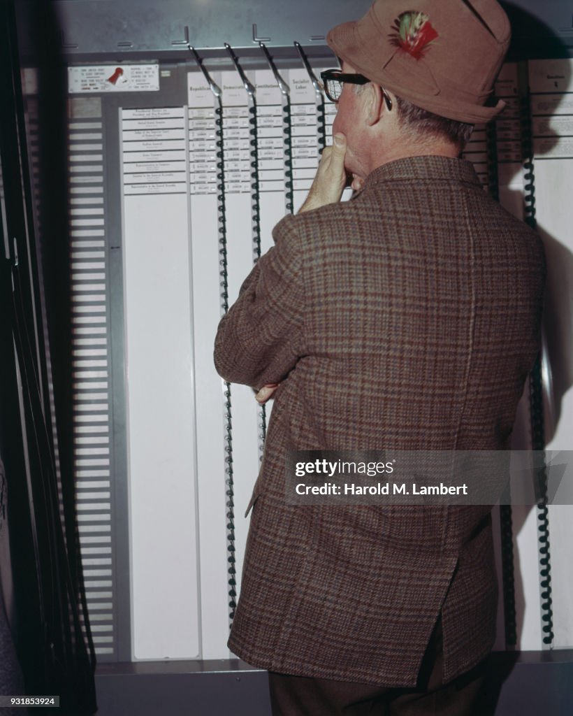 Man looking at voting machine