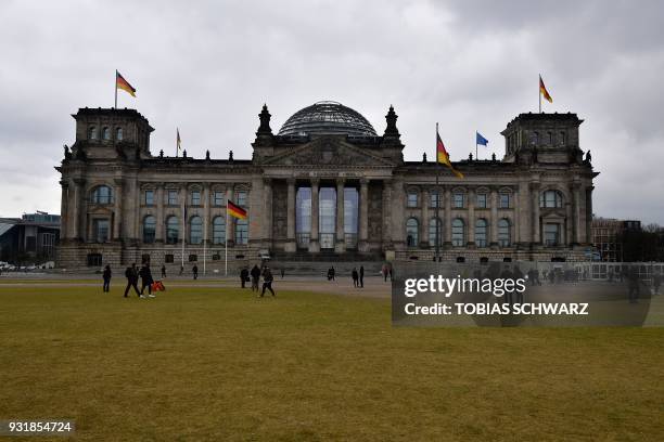 The Reichstag housing the Bundestag is pictured on March 14, 2018 in Berlin, as the new German government was sworn in here. German Chancellor Angela...