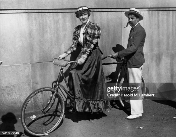 Man and woman riding on two person bicycle