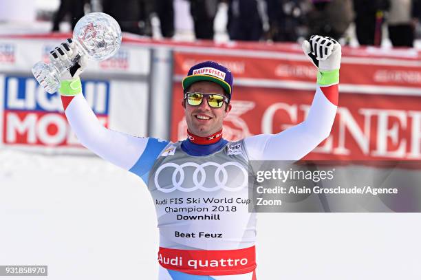 Beat Feuz of Switzerland wins the globe in the men downhill standing during the Audi FIS Alpine Ski World Cup Finals Men's and Women's Downhill on...