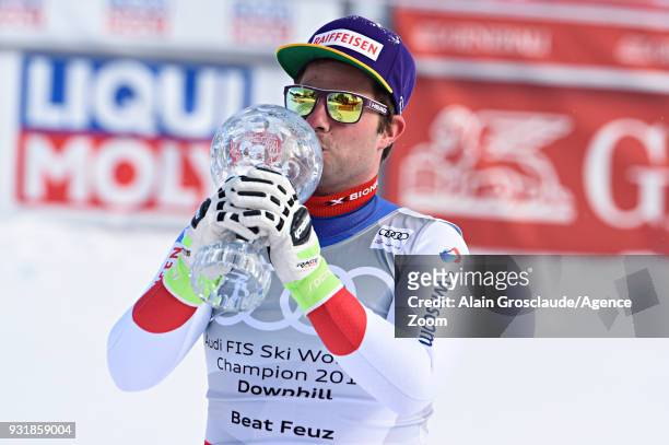 Beat Feuz of Switzerland wins the globe in the men downhill standing during the Audi FIS Alpine Ski World Cup Finals Men's and Women's Downhill on...