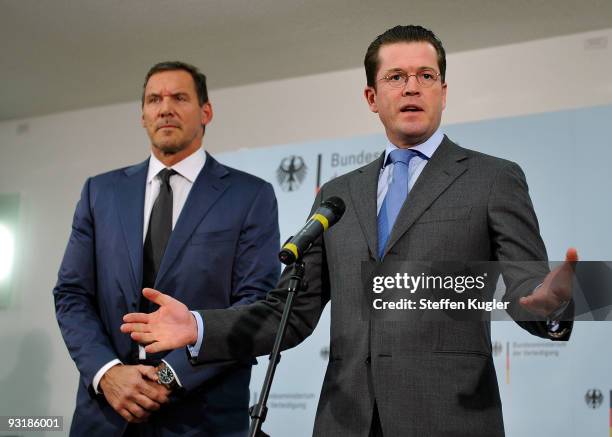 German Minister of Defense Karl Theodor zu Guttenberg gestures as he speeks to the media during together with actor Ralf Moeller at Bendlerblock on...