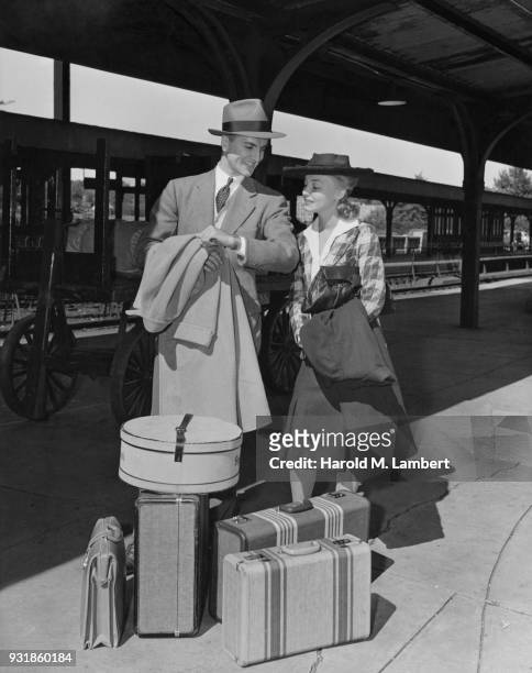 Couple waiting for train on railroad station platform