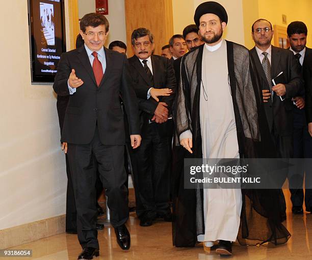 Turkey's Foreign Minister Ahmet Davutoglu and Ammar al-Hakim , leader of the Iraqi Supreme Islamic Council walk after their meeting in Istanbul on...