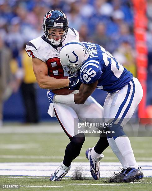 Kevin Walter of the Houston Texans runs with the ball while tackled by Jerraud Powers of the Indianapolis Colts during the NFL game at Lucas Oil...