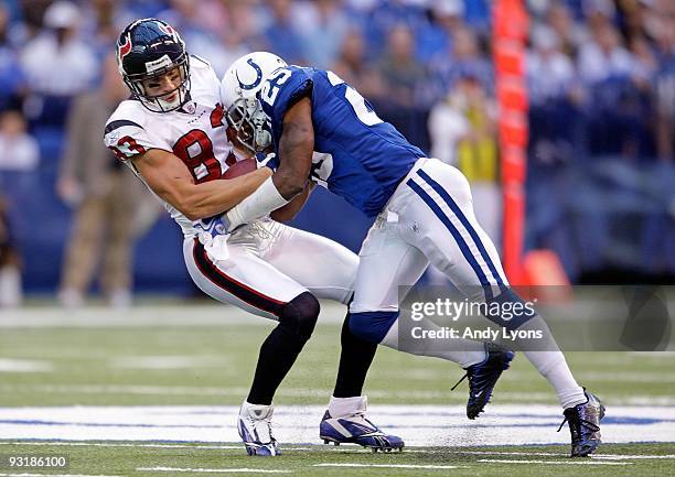 Kevin Walter of the Houston Texans runs with the ball while tackled by Jerraud Powers of the Indianapolis Colts during the NFL game at Lucas Oil...