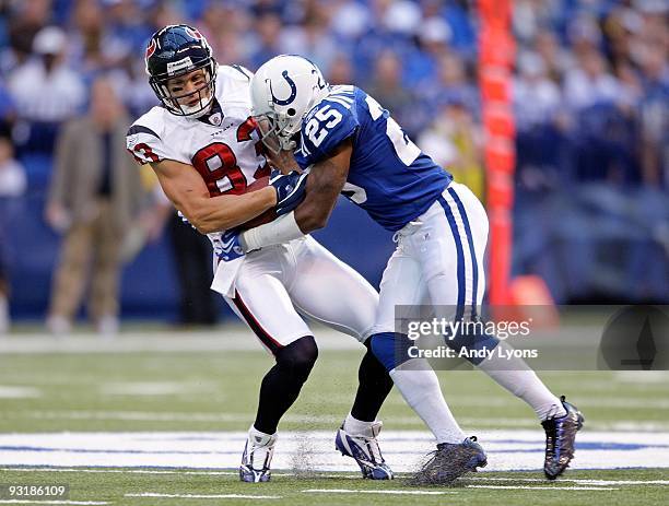 Kevin Walter of the Houston Texans runs with the ball while tackled by Jerraud Powers of the Indianapolis Colts during the NFL game at Lucas Oil...