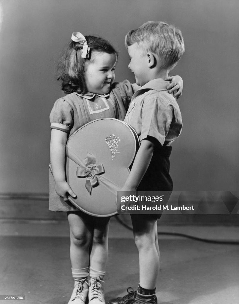 Boy giving Valentine present to girl