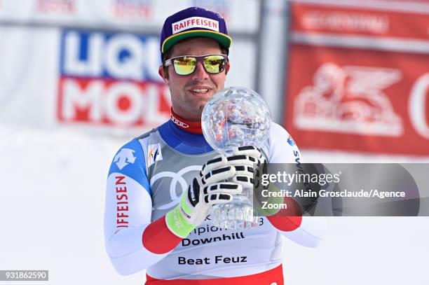 Beat Feuz of Switzerland wins the globe in the men downhill standing during the Audi FIS Alpine Ski World Cup Finals Men's and Women's Downhill on...