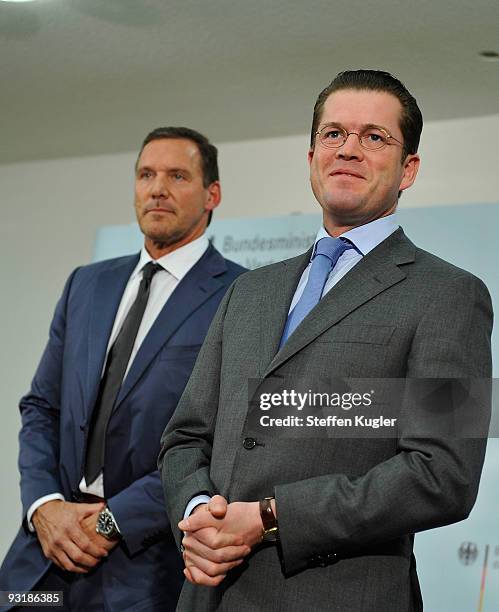 Actor Ralf Moeller and German Minister of Defense Karl Theodor zu Guttenberg stand next to each other as they adress the media at Bendlerblock on...