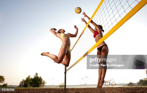 spike and block - beach volleyball spike stock pictures, royalty-free photos & images