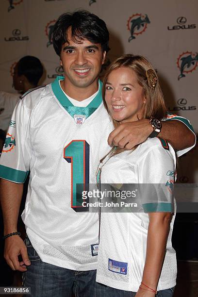 Luis Fonsi and Adamari Lopez attend the Dolphins game at Landshark Stadium on October 12, 2009 in Miami, Florida.