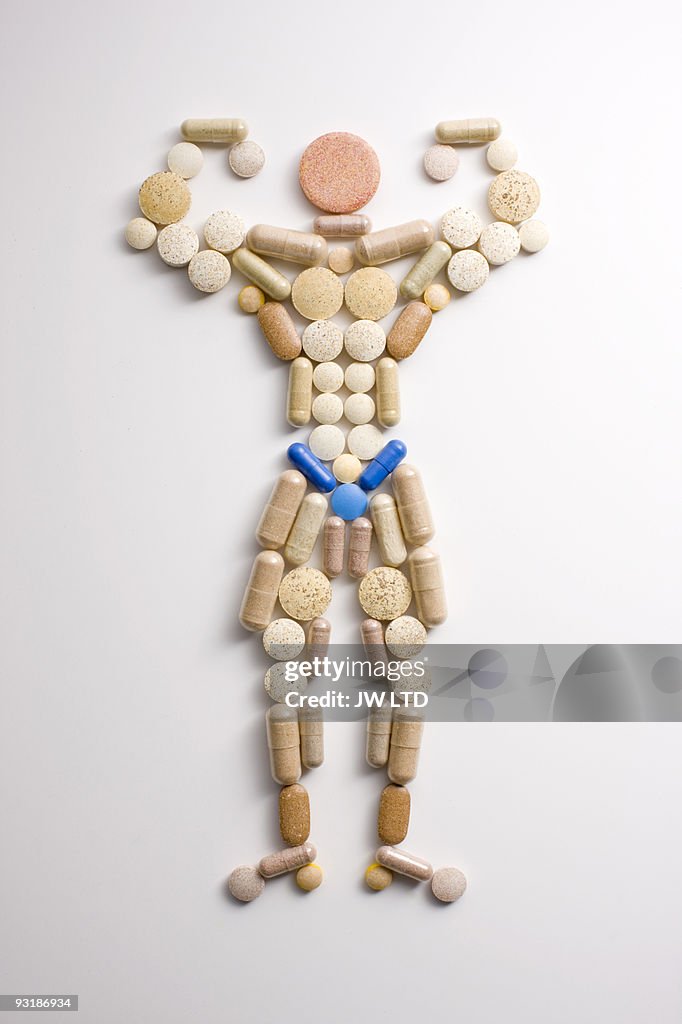 Vitamin pills in shape of man flexing muscles