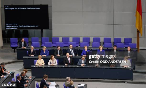 German Chancellor Angela Merkel and ministers of her new cabinet have taken seat on the government's bench during a session at the Bundestag on March...