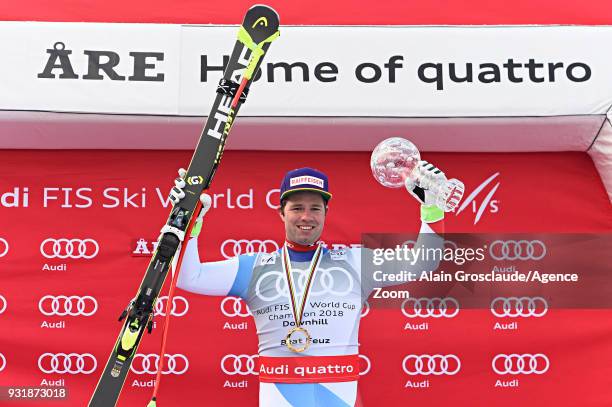 Beat Feuz of Switzerland wins the globe in the men downhill standing during the Audi FIS Alpine Ski World Cup Finals Men's and Women's Downhill on...