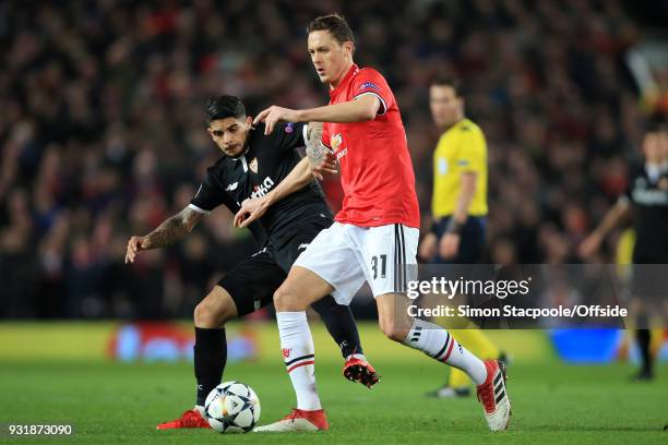 Nemanja Matic of Man Utd battles with Ever Banega of Sevilla during the UEFA Champions League Round of 16 Second Leg match between Manchester United...