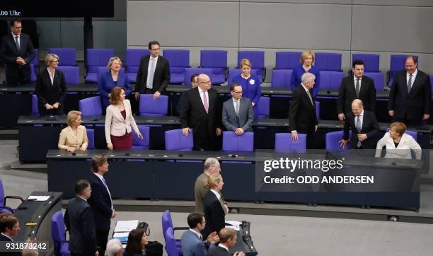 German Chancellor Angela Merkel and ministers of her new cabinet take seat on the government's bench during a session at the Bundestag on March 14,...