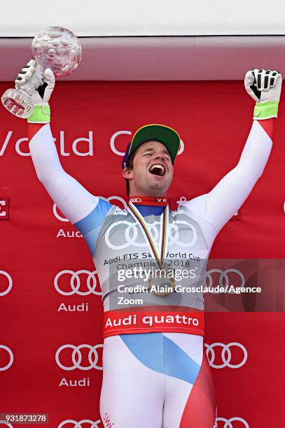 Beat Feuz of Switzerland wins the globe in the men downhill standing during the Audi FIS Alpine Ski World Cup Finals Men's and Women's Downhill on...