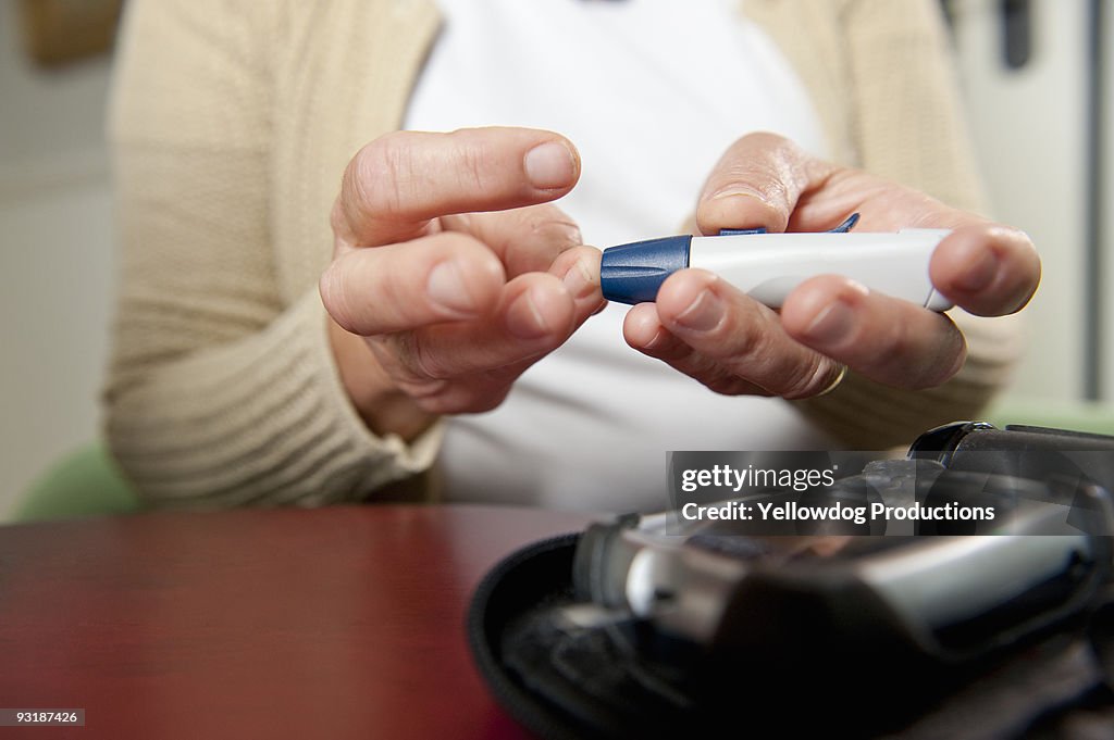 Woman using diabetes test kit