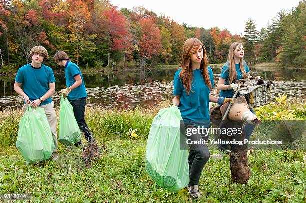 student volunteers doing garbage cleanup - environmental cleanup stock pictures, royalty-free photos & images
