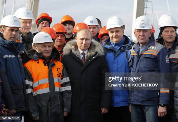 Russian President Vladimir Putin inspects the road section of the road-and-rail Crimean Bridge over the Kerch Strait on March 14, 2018.